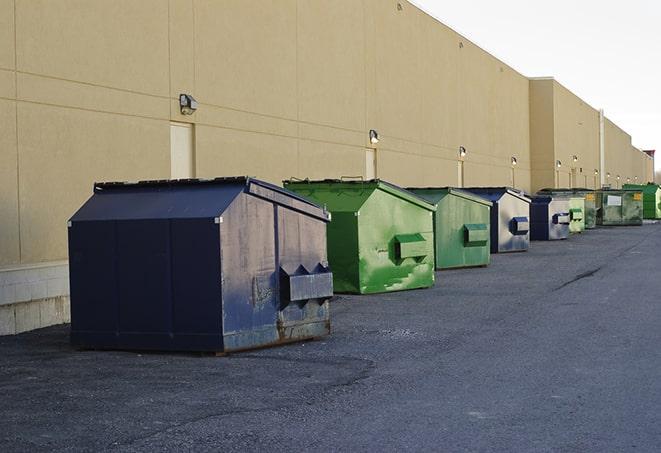 a series of colorful, utilitarian dumpsters deployed in a construction site in Aguanga